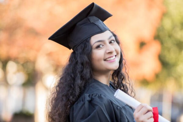 Teenage happy Indian female graduates high school